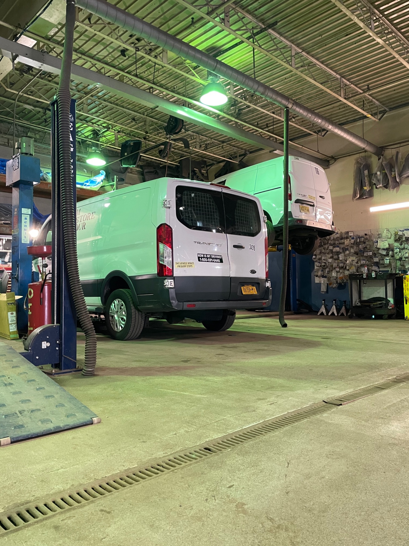 Van on lift in maintenance bay